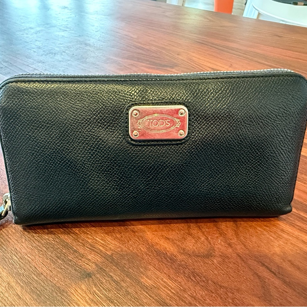Tod’s Classic Black Pebbled Leather Zippered Wallet.